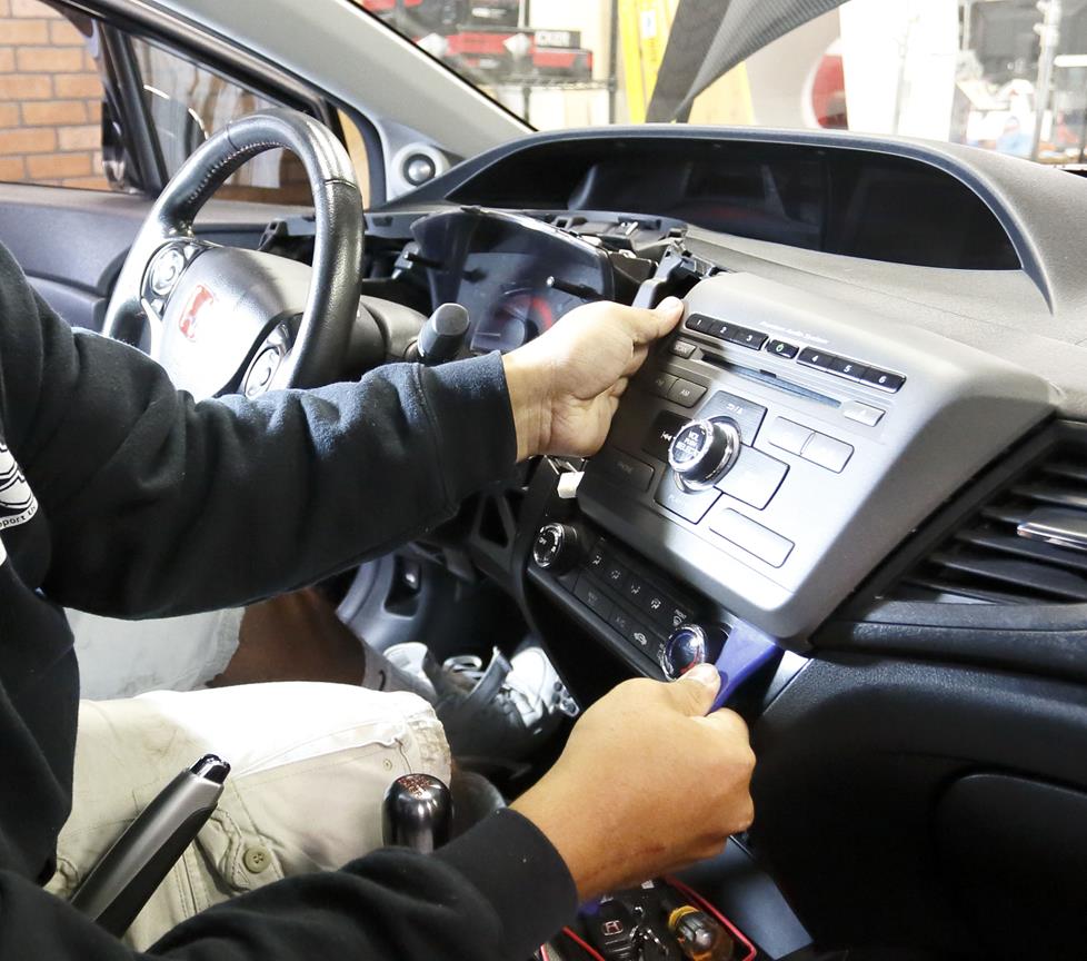 Steven removing dash panels to access the radio.